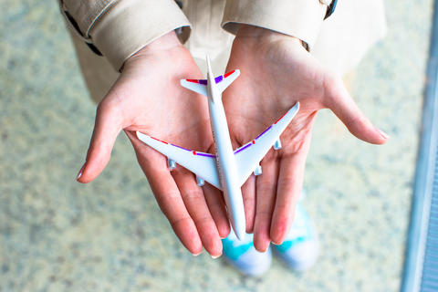 man holding toy airplane in palm