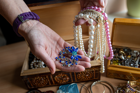 hand sorting through jewelry