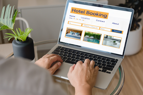 woman booking hotel on laptop