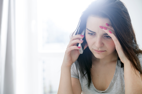 woman with worried face on call