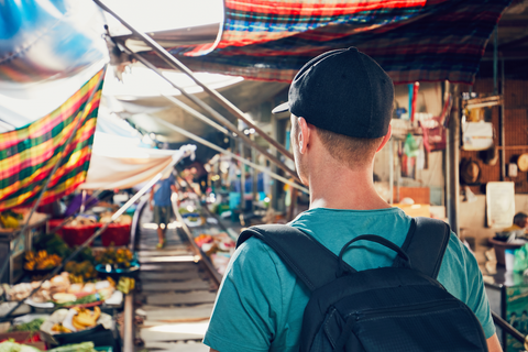 tourist in market with cap and backpack