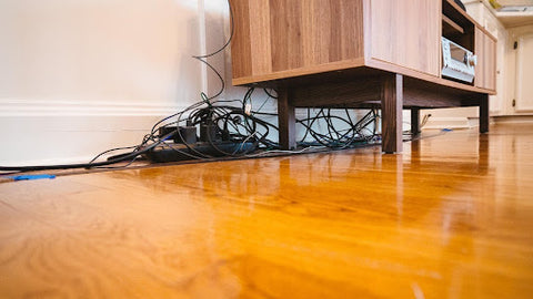 tangled cables under drawers unit