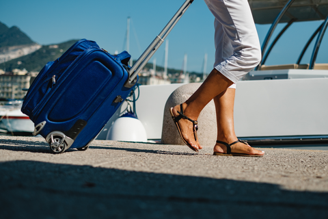 woman walking in airport with suitcase