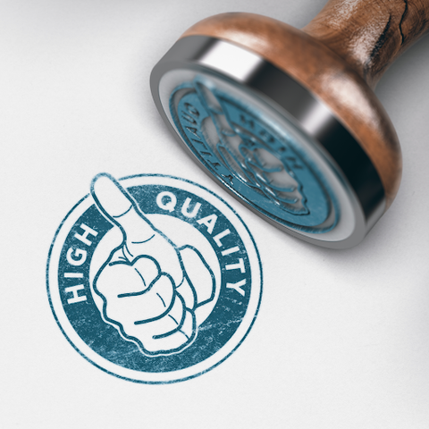A wooden and steel stamp with blue ink showing high quality