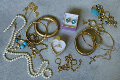 A variety of jewelry in gold, pearls and blue stones