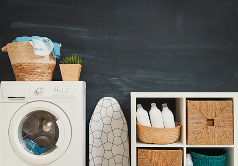 A washing machine and baskets in a laundry room