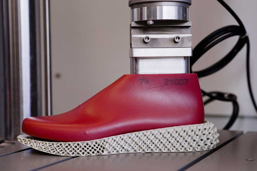 Researchers measure the stiffness of midsole designs using an Instron machine to mimic footsteps. Credit: Melanie Gonick, MIT