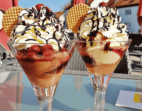 two sundaes with chocolate and cherries