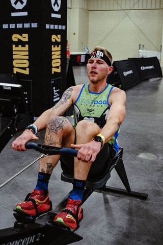MudGear athlete Alexander Golik hits the rowing machine in blue MudGear ruck socks