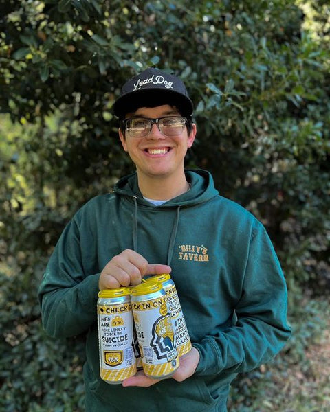 Brewer holding a four-pack of Hi How Are You beers they brewed