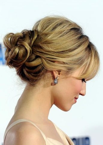 blonde haired woman with pull-through up-do