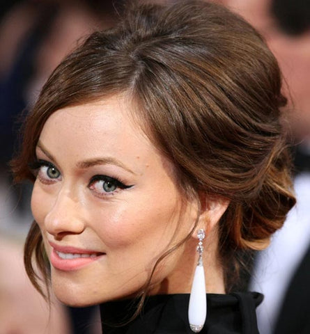 Olivia Wilde with brown hair in a low bun