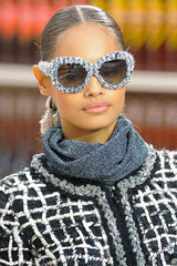 model wearing sunglasses with center parted hair