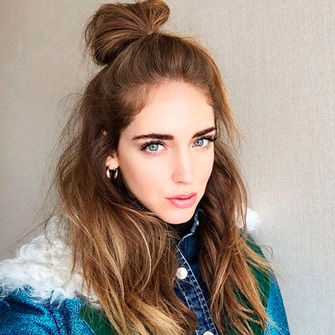 woman with hair in a bun wearing a jacket