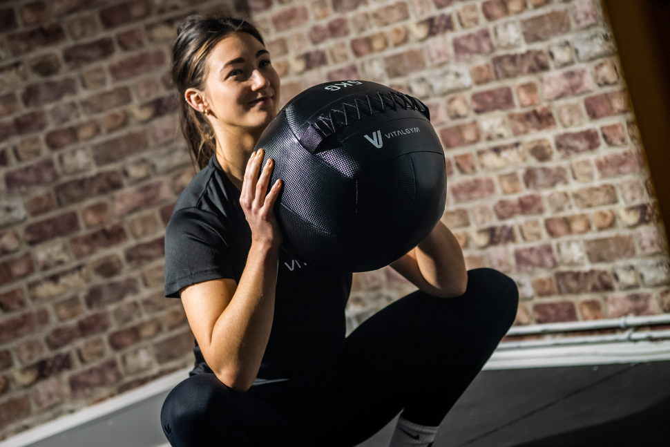 Model squatting with a medicine ball