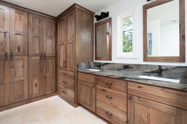 Remodeled Master Bathroom by Jackie Lopey of Wide Canvas with Custom Wirebrushed Knotty Alder Cabinets, Closet Removed and Replaced with Built-In Wardrobe Cabinets, Double Vanity and Sinks, Black Plumbing Fixtures