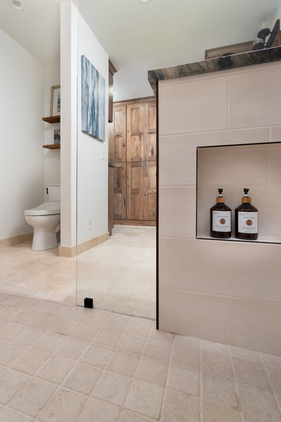 Remodeled Master Bathroom by Jackie Lopey of Wide Canvas with Custom Wirebrushed Knotty Alder Cabinets, Wetroom, Semi-Private Toilet Alcove Room, Travertine Floor