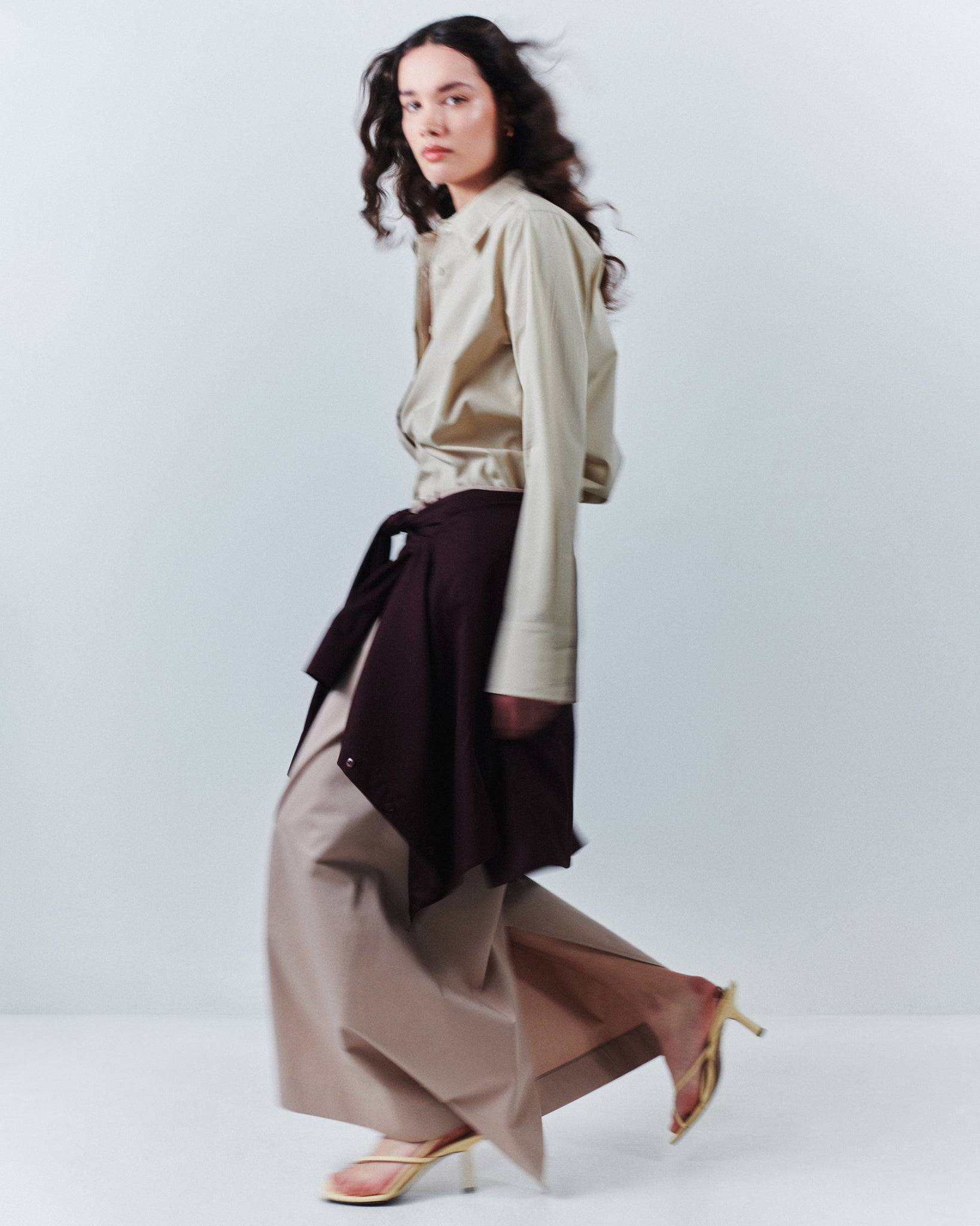 model wears Issue Twelve blush and stone coloured cotton skirt and shirt