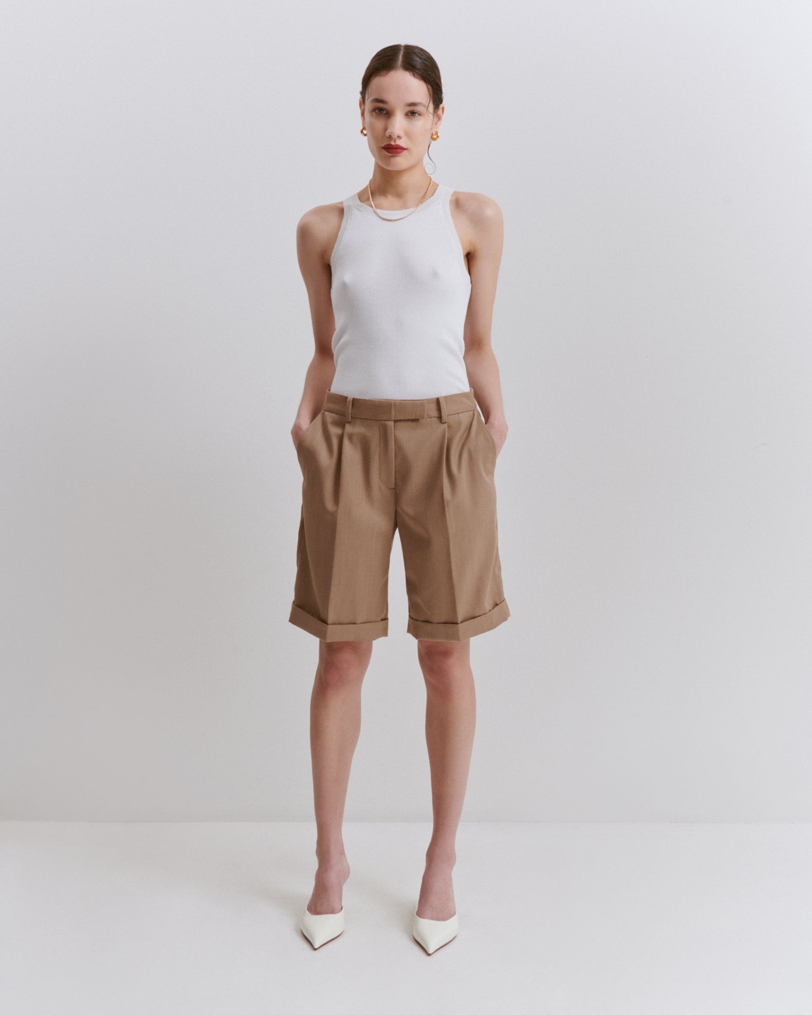 model wears Issue Twelve white cotton vest top with camel wool shorts