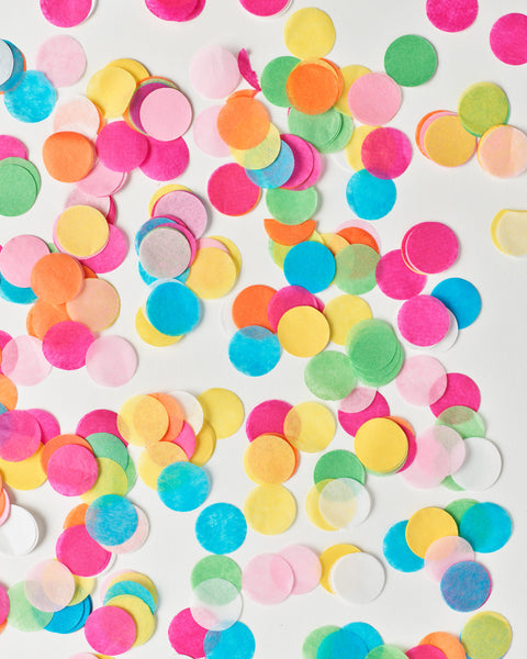 Knot and Bow circle confetti in assorted bright colors scattered over a white background.