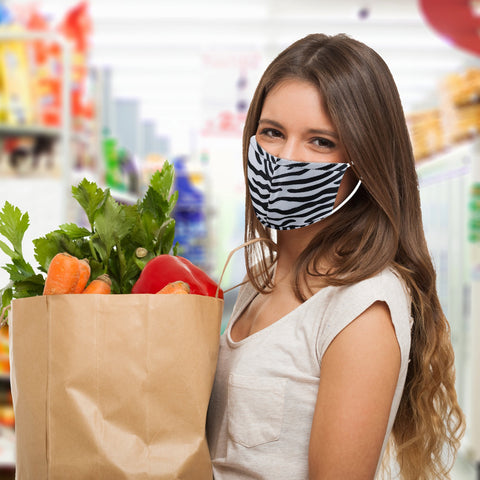 woman in zebra face mask with groceries