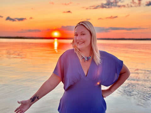 Maggie Mae in front of the sun rising on the Jersey Shore