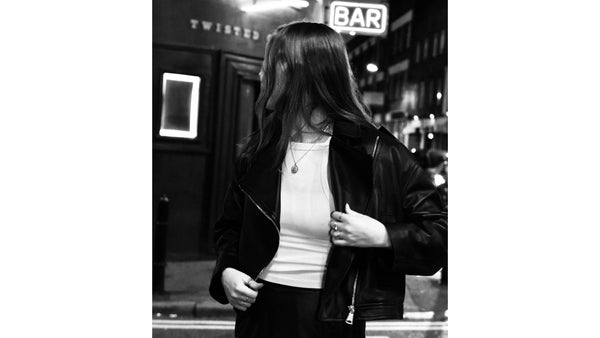 Model-wears-white-t-shirt-and-leather-biker-jacket