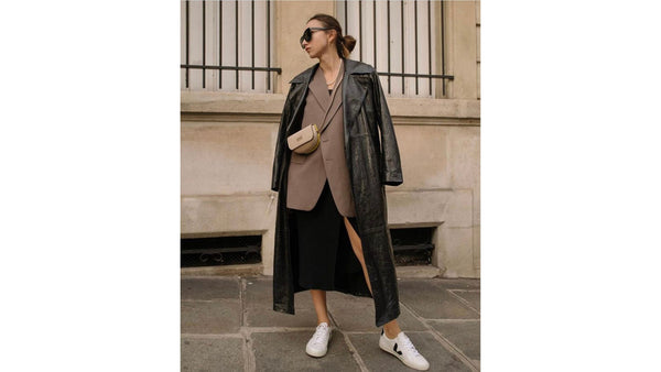 SKIIM-girls-wears-a-brown-blazer-with-black-leather-Karla-trench-coat-on-top-with-a-black-skirt-and-vejas