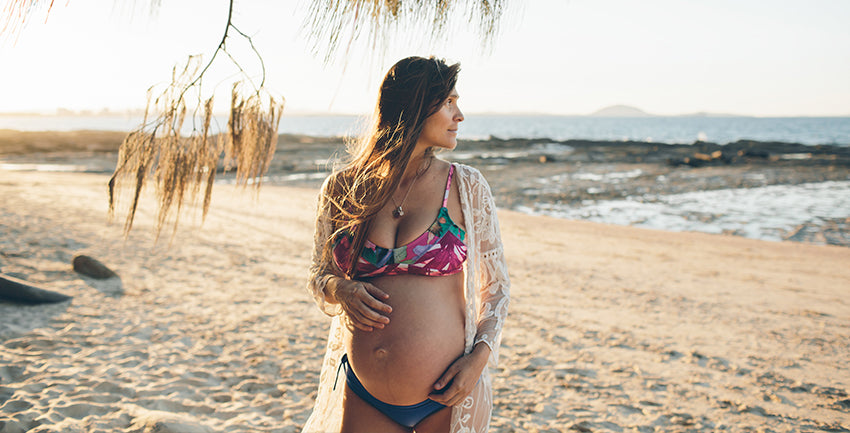 Photo of me pregnant with a Dkoko bikini at the beach