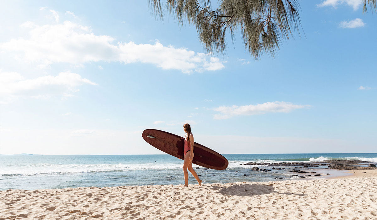 Tia is wearing the Harmony One piece ruffled surf bikini in Clay