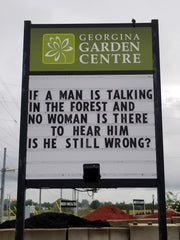 georgina garden centre road sign if a man is talking in the forest