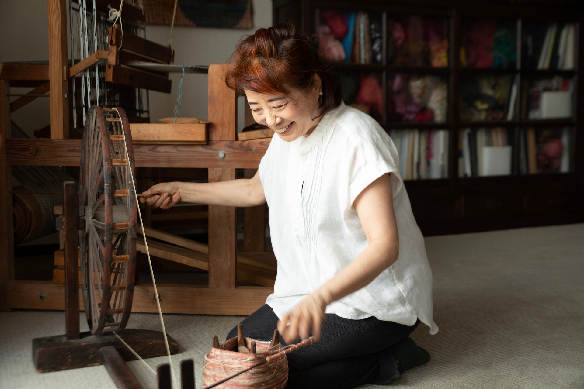 Asakura Mitsuko spinning yarn in her studio. Photo © Mika Sasaki