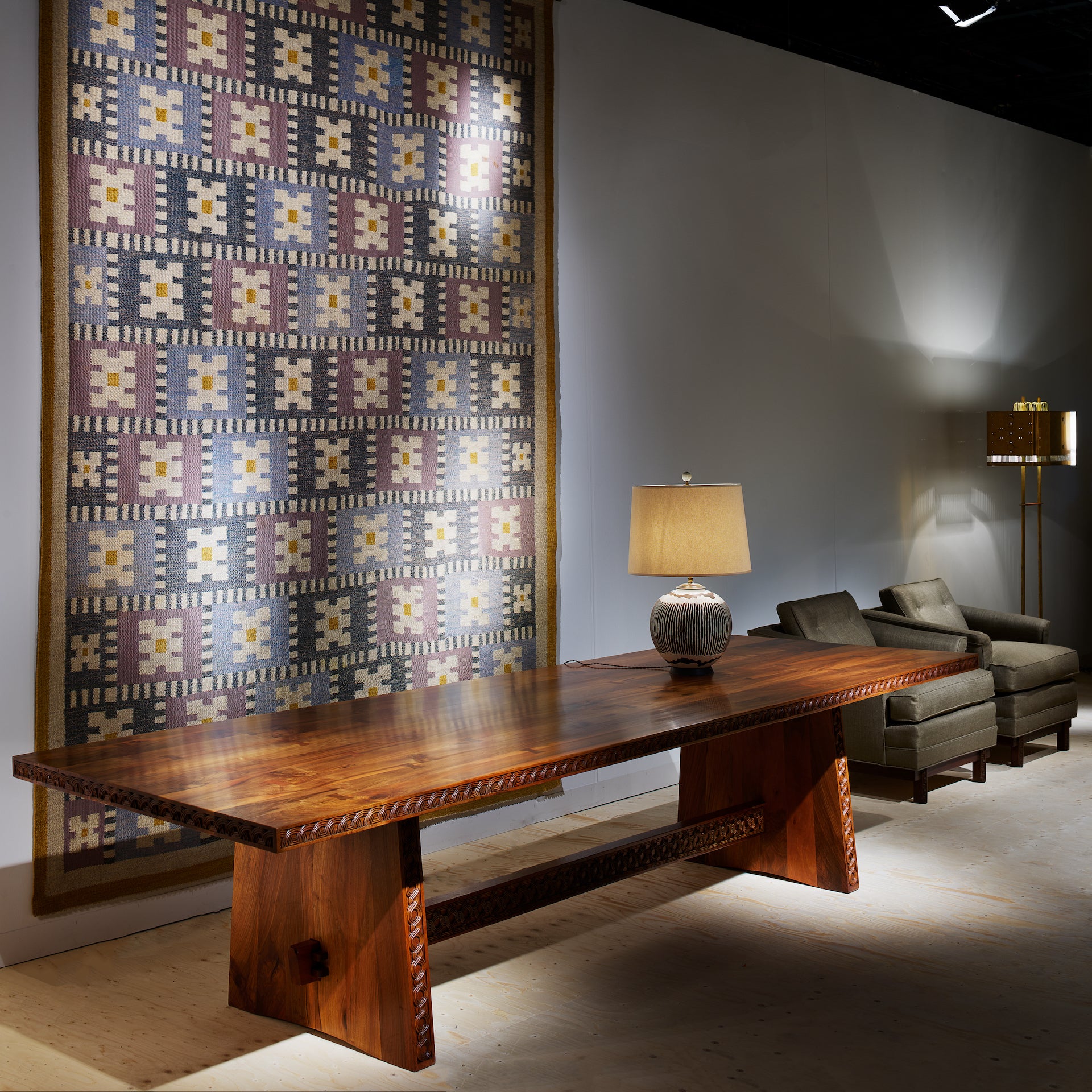 Walnut Table by Dénies György (c. 1920) and Anémones des Bois Tapestry by Sigvard Bernadotte (c. 1940), presented by Galerie Eric Philippe at Design Miami/ Basel 2023. Photo © James Harris for Design Miami/ Basel