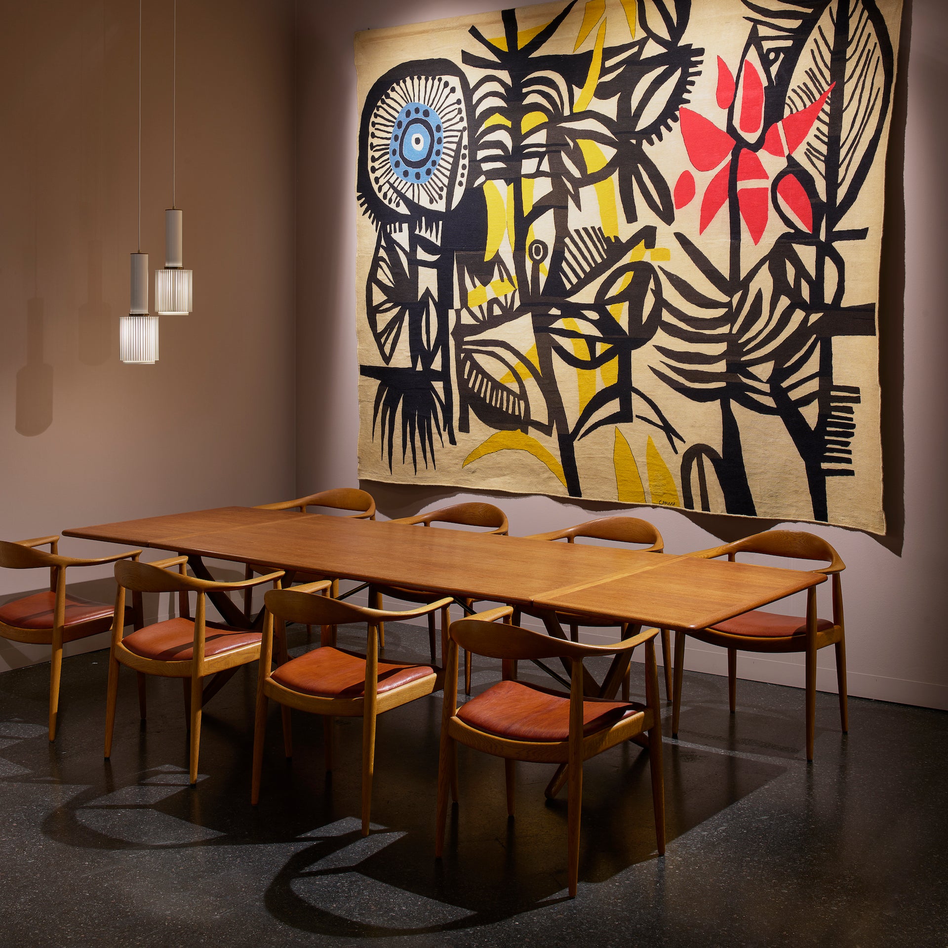 Oak & Brass Table (1960) and Round Chairs (1949) by Hans Wegner and Untitled Tapestry by Genaro De Carvalho (c. 1965), presented by Gokelaere & Robinson at Design Miami/ Basel 2023. Photo © James Harris for Design Miami/ Basel