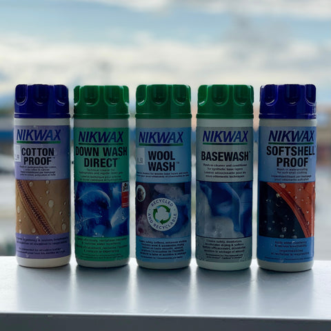 5 Bottles of Nikwax products. From left to right Cotton Proof, Down Wash Direct, Wool Wash, Basewash, and Softshell Proof.