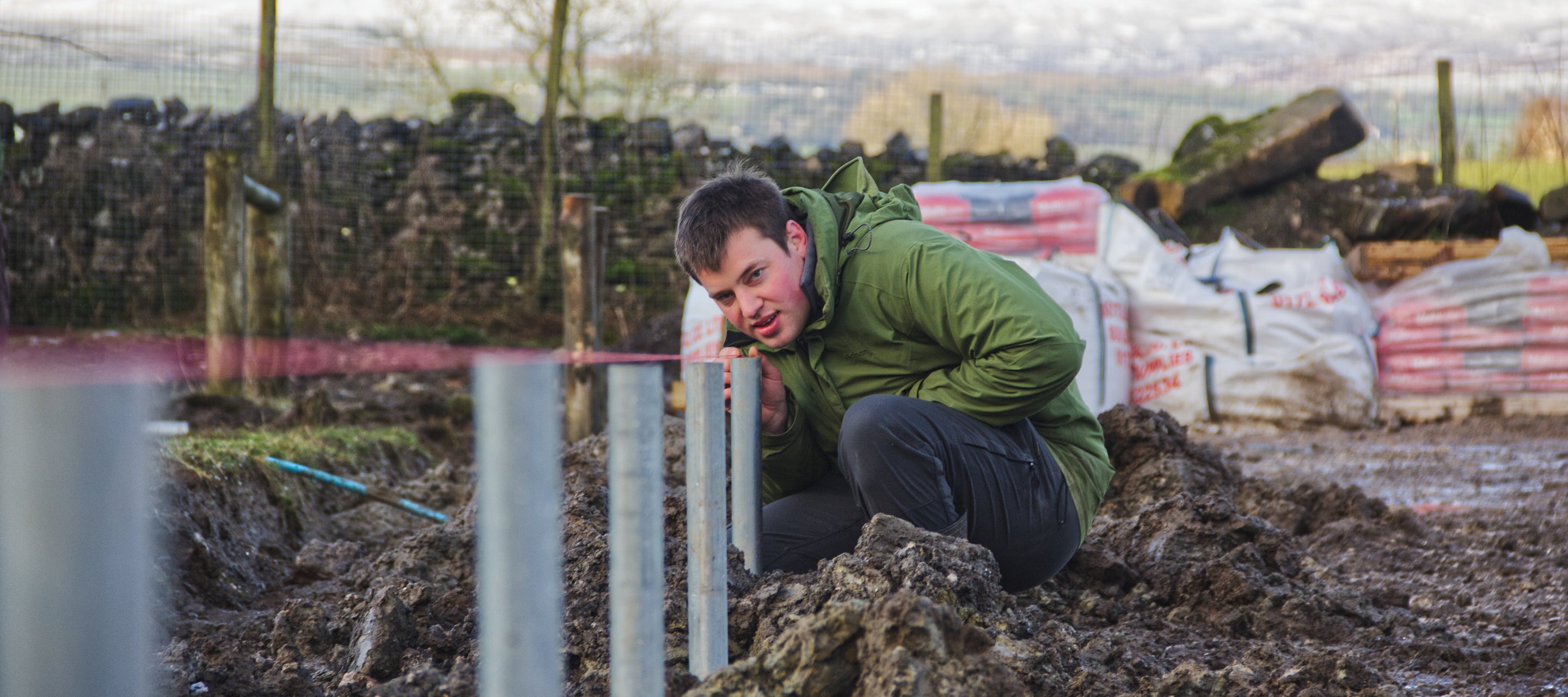 Jimmie draws a line down the edge of what will be his new polytunnel
