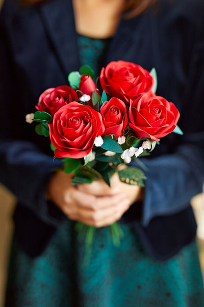 Woman receiving handcrafted red paper roses