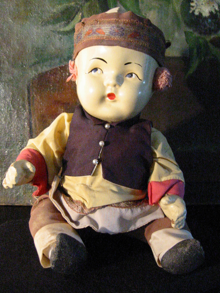 chinese doll in glass case