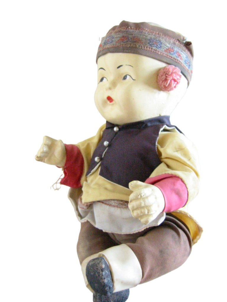 chinese doll in glass case