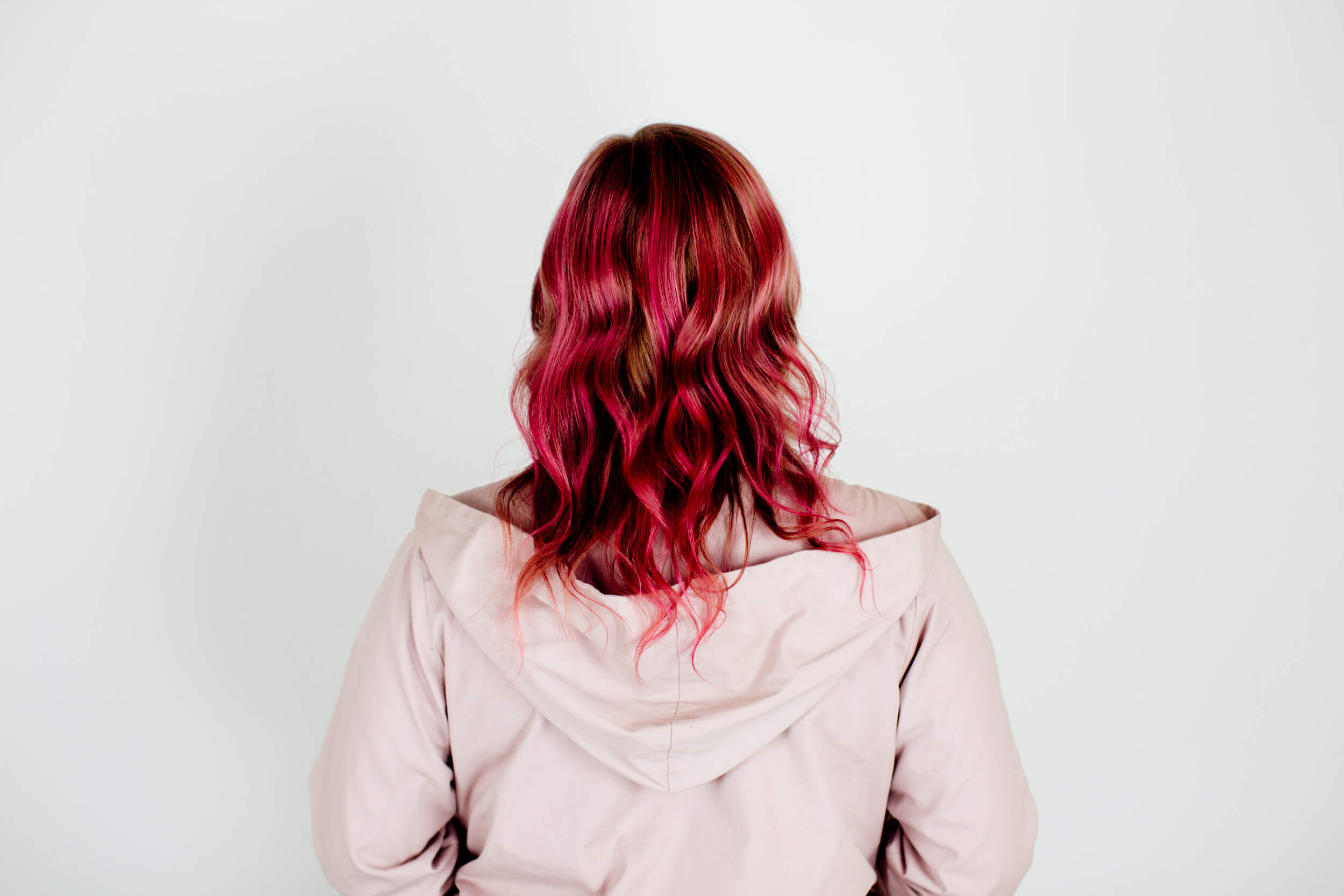 A woman with pink hair from the back.