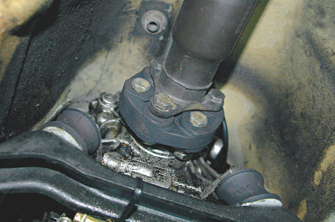 The E30 driveshaft is a two-piece driveshaft with a rubber coupling and single U-joint for the front half, a solidly mounted center support bearing with a section of sliding splines in the middle, and a rear U-joint. The center support bearing and front rubber flex coupling are replaceable but the two U-joints are swedged in place in the factory driveshaft. (Photo Courtesy Vorshlag Motorsports)