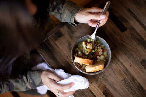 clam chowder, hands holding spoon and napkin