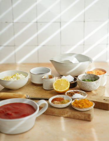 photo of an array of spices and seasonings set in a brightly lit kitchen