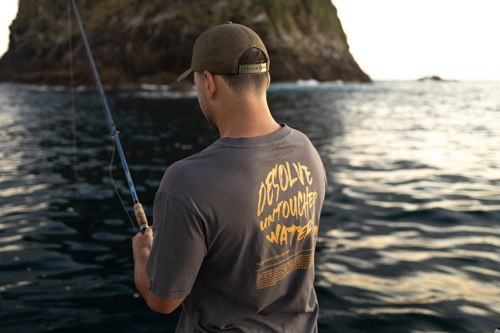 Puka catching live bait wearing the Desolve Untouched Tee - Ash