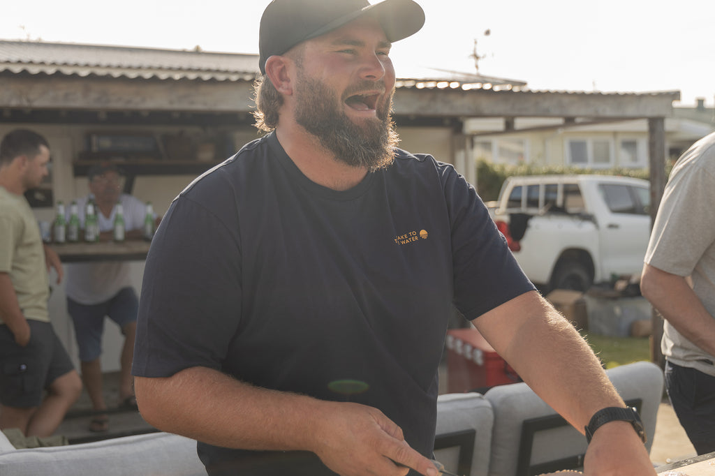 Greeny filleting the fish from the day out - Wearing the Desolve Classic TTTW Tee - Navy