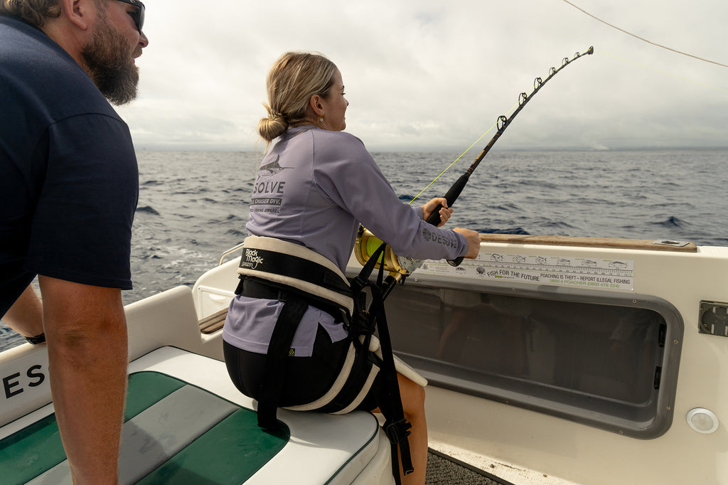 Jacey fighting her marlin as Greeny looks on. Jacey wearing the Desolve Ripple Crew Womens - Lavender from the womens Thrill Chaser Div. collection