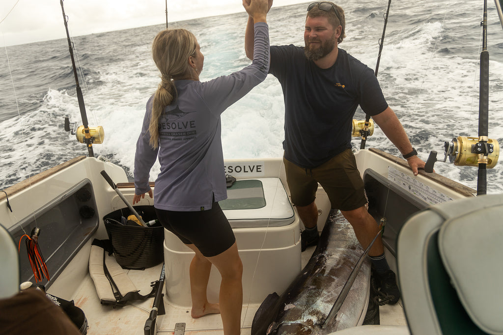 Jacey and Greeny celebrate after hauling in the marlin. Jacey wearing the Desolve Ripple Crew Womens - Lavendar