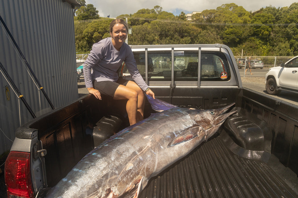 Jacey with her marlin at Tasman Marine before it gets taken to be filleted and smoked - Wearing the Desolve Ripple Crew Womens - Lavender