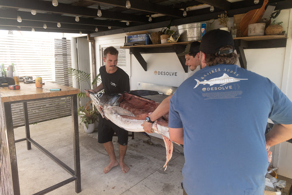 Max, Drew and Greeny flipping the marlin over to be filleted on the other size. Greeny and Max weaing the two colours of the Desolve Audax Tee - Vintage Blue & Black colours