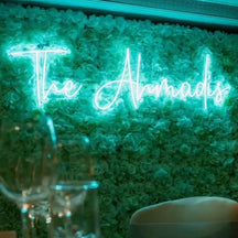 Green Surname Wedding Neon Sign with floral wall.jpg__PID:35636a01-ce87-456a-a56a-496ab5361a1b
